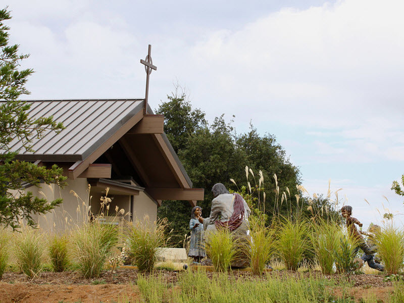 Master Teacher statues with Chapel in the backgound