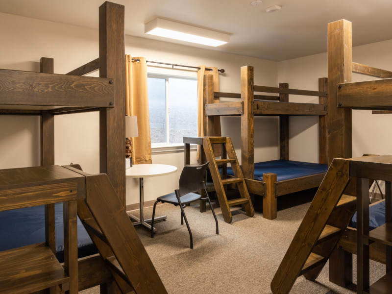 Disciples Lodge room with three bundbeds and table