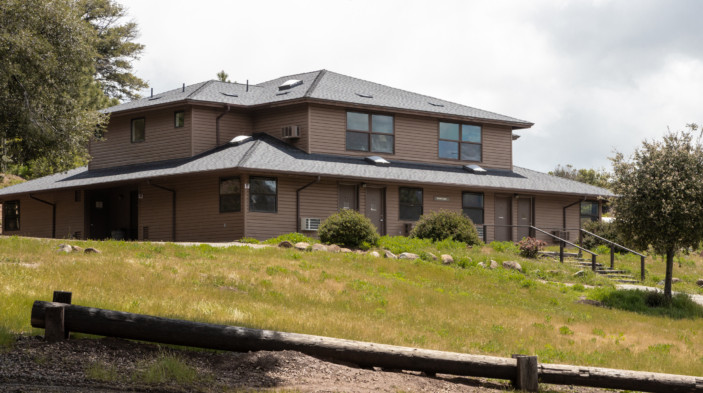 Milner Lodge exterior with grassy hill and steps