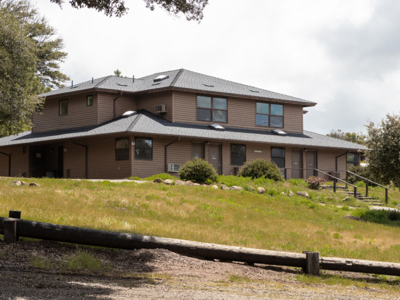 Milner Lodge exterior with grassy hill and steps