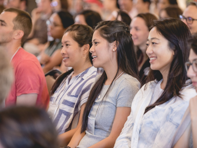 Young Adult women in /founders Hall listening to speaker during retreat