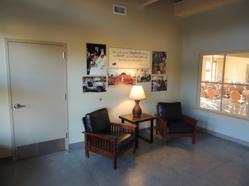 Foyer seating in Shepherds Hall with photos on wall