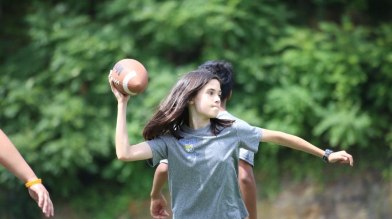 Girl throwing football