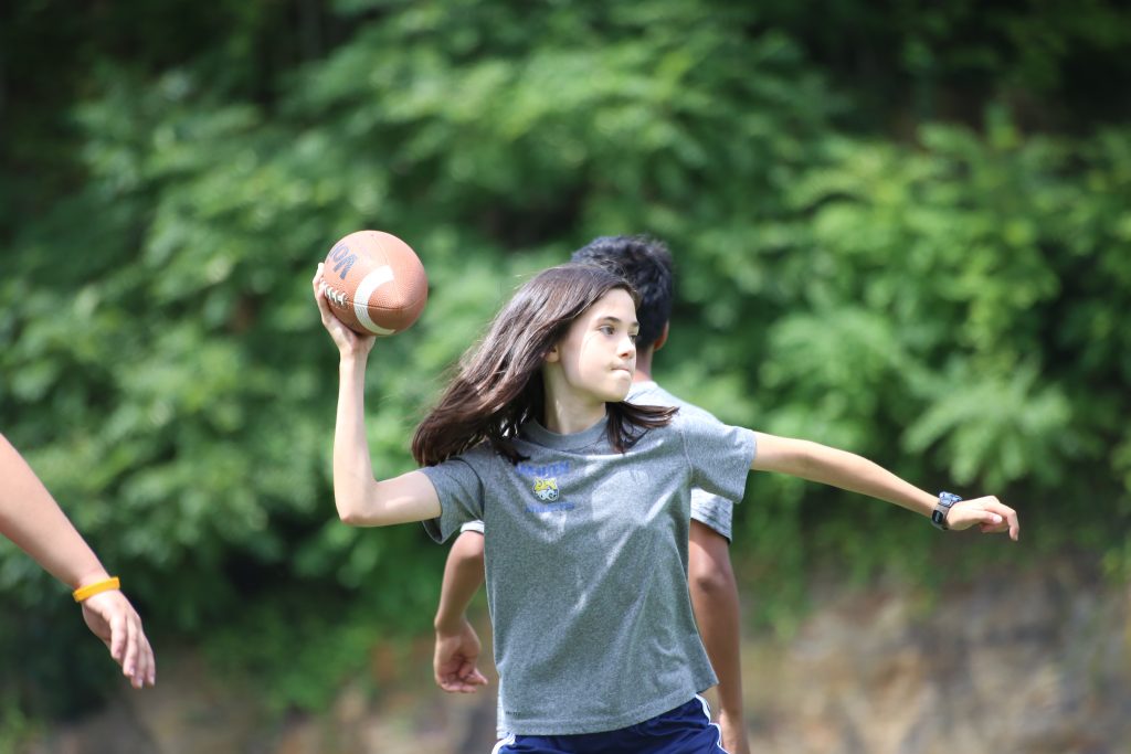 Girl throwing football