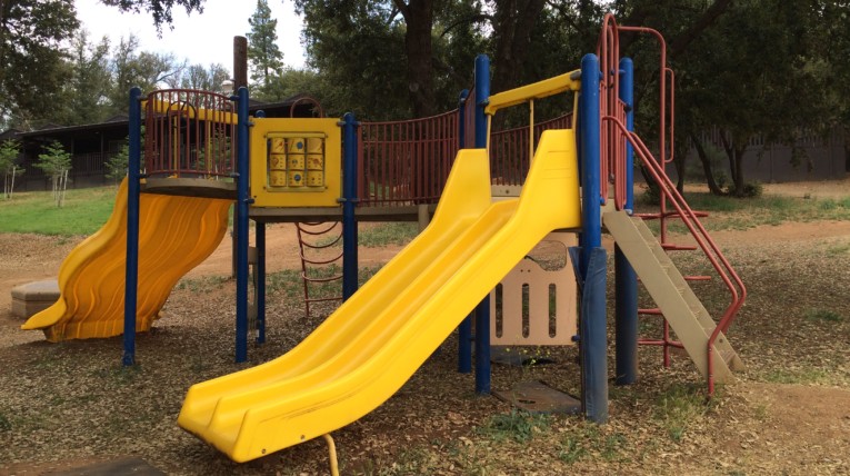Playground set with two yellow plastic slides