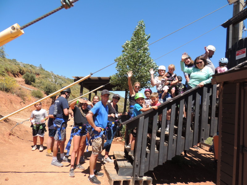 Family campers on steps in line for a zipline ride