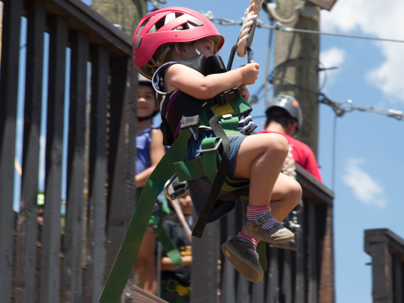 Young girl on zipline during family camp
