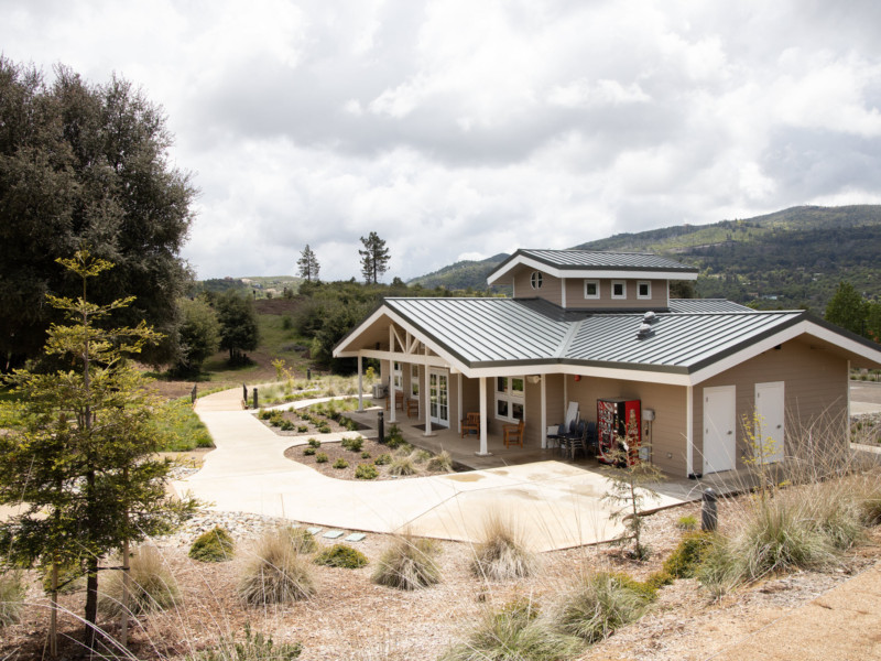 Welcome Center back with trees and clouds