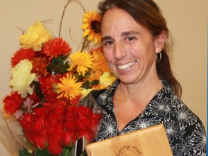 2015 Women's Auxiliary Woman of the Year holding flowers