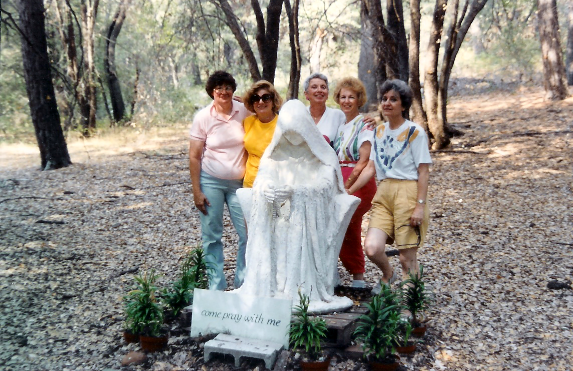 Old staue of Mary with a group of women from 1988