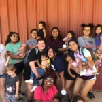 YoungLives moms with children posing near Dining Hall