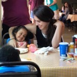 Mom with child at table eating lunch in Dining Hall