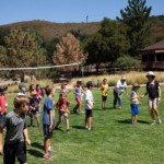 Children and WWWA volunteers on meadow playing games