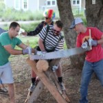 Dads sawing a log during a Family Camp contest