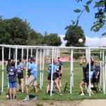 Adults playing 9 square on meadow