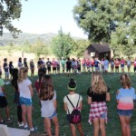 Children in a circle on meadow during Family Camp games