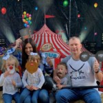 Family of five in front of circus tent at Family Camp