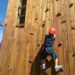 Young boy on climbing wall